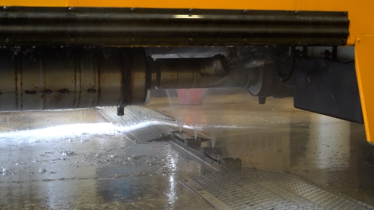 The Neutralizer undercarriage wash system in a fleet wash bay